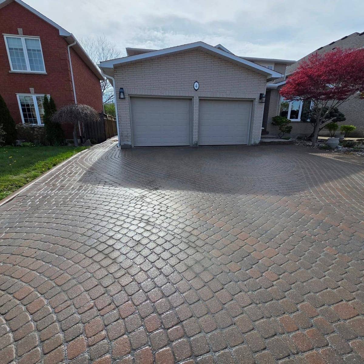 Renovated Hamilton home with a finished interlock stone driveway by Unlimited Services