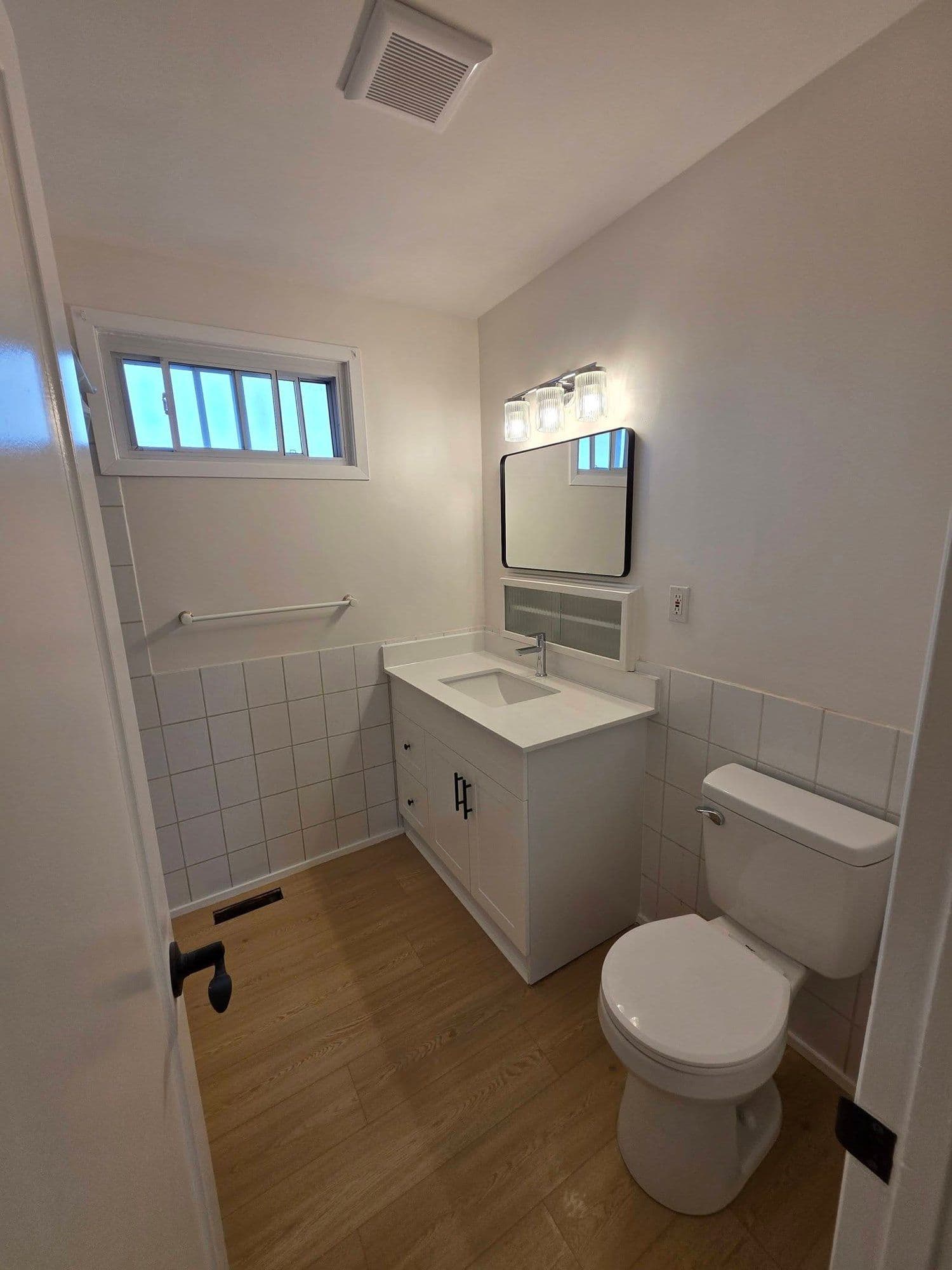 Renovated bathroom with new vanity and tile by Unlimited Services