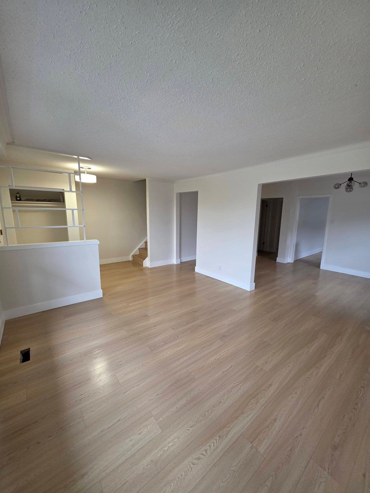 Open-concept living room with new luxury vinyl plank flooring